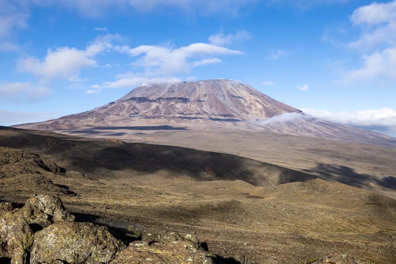 Scenic view of mount kilimanjaro peak with volcanic landscape and blue sky in tanzania africa